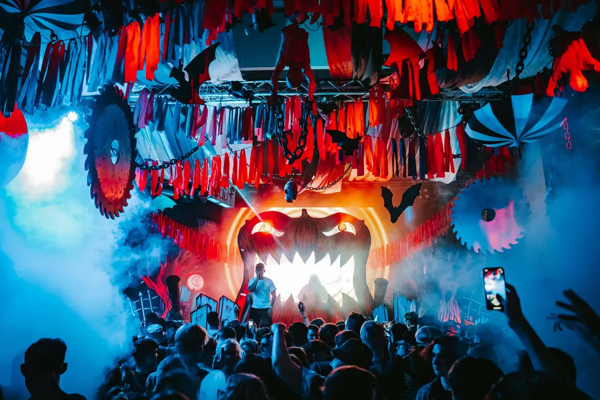 Halloween themed nightclub event with theatrical production and performers