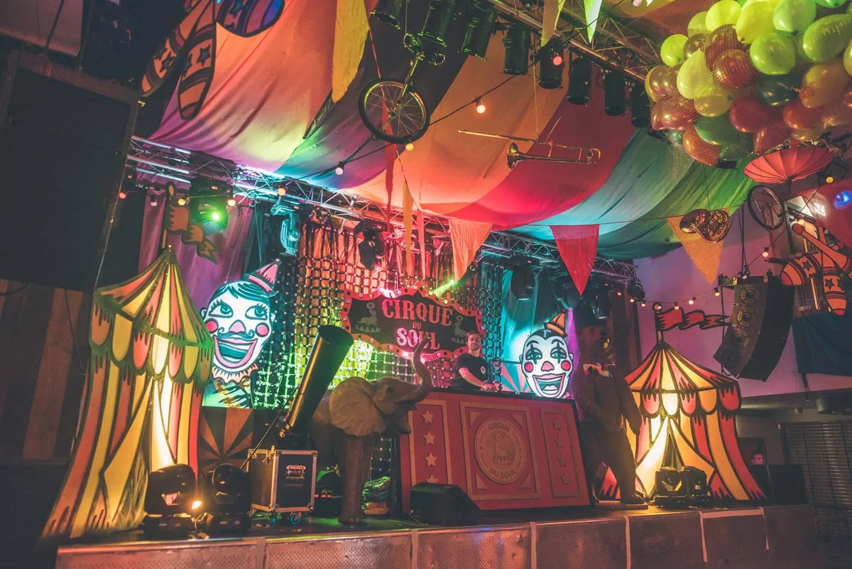Circus performer on stage with theatrical lighting